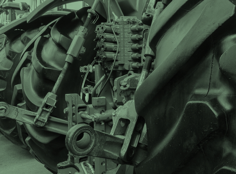A close up of linkage parts on a tractor
